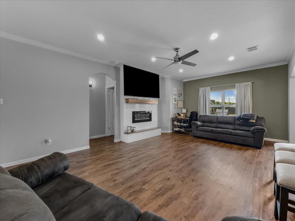 14201 Bridgeview Lane Dallas, TX 75253 - Photo 3 of 26 a living room with furniture flat screen tv and fireplace