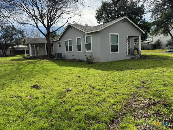 a front view of house with yard and green space