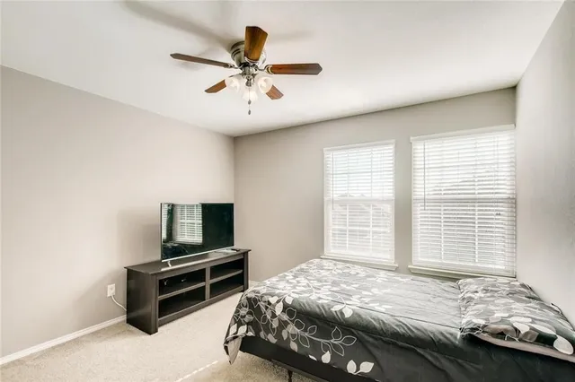 a bedroom with a bed and a tv