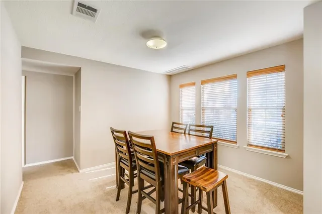 a view of a dining room with furniture and windows