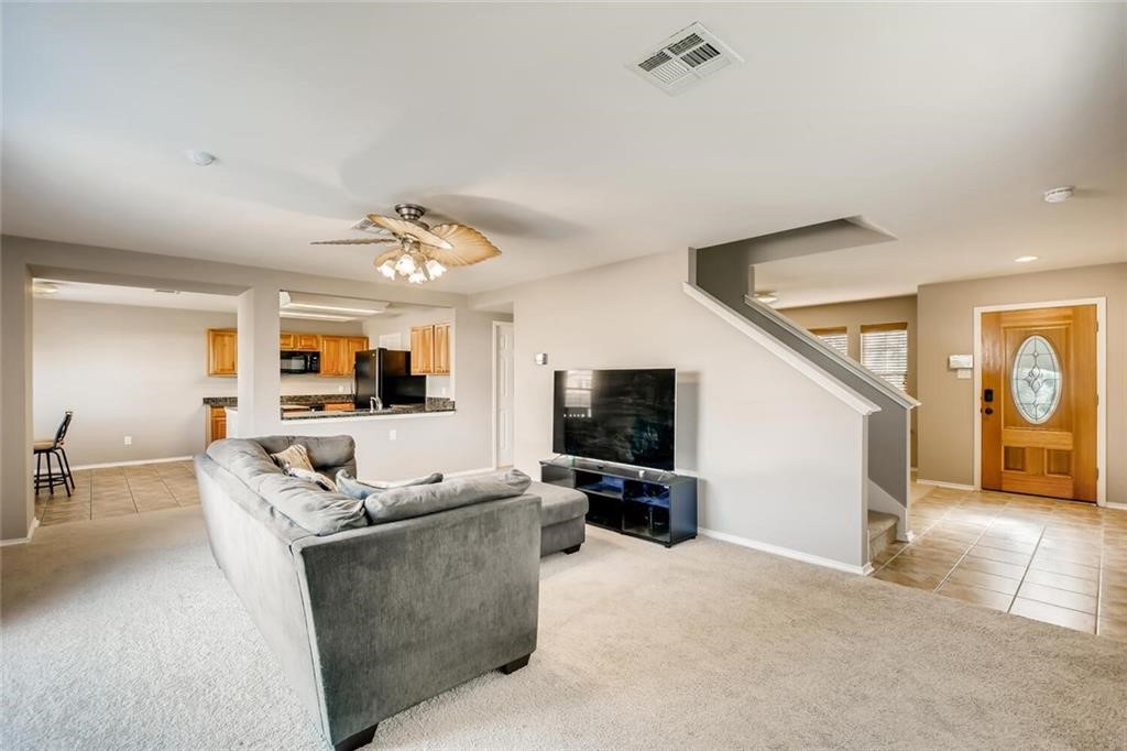 1149 Apollo Circle Round Rock, TX 78664 - Photo 9 of 14 a living room with furniture and a flat screen tv