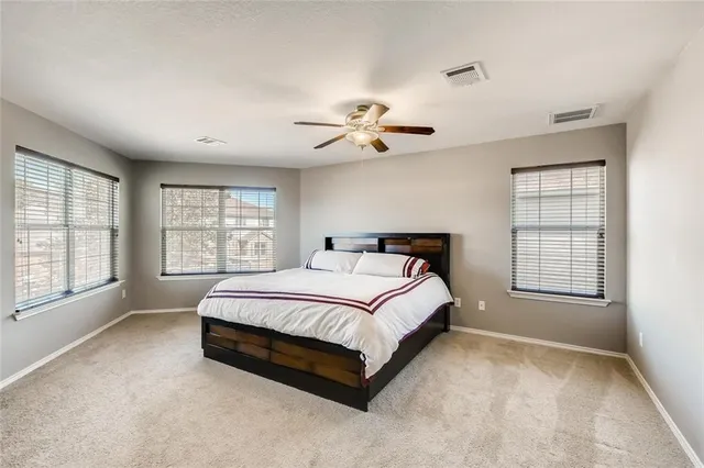 a spacious bedroom with a bed and a window