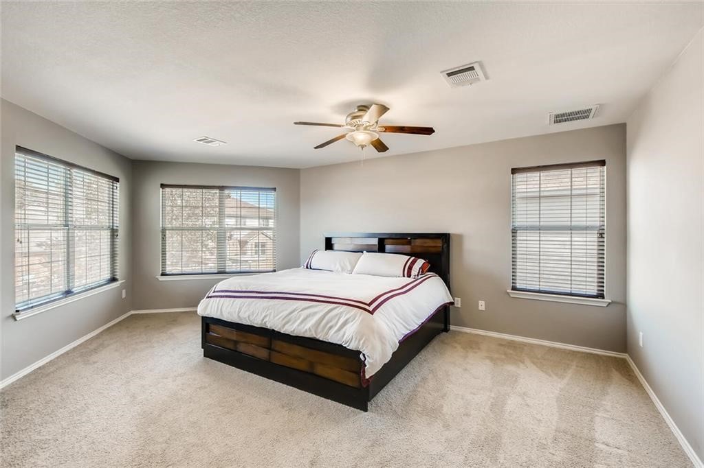 1149 Apollo Circle Round Rock, TX 78664 - Photo 10 of 14 a spacious bedroom with a bed and a window