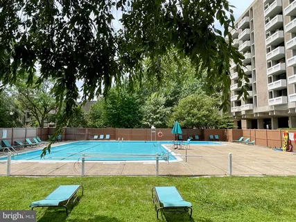 a view of a swimming pool with a yard