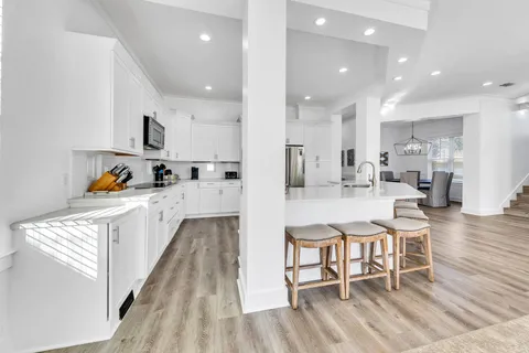 a view of a kitchen with a sink and chandelier