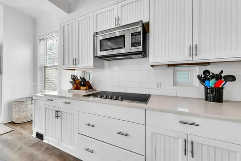 a view of a hallway with furniture and a window