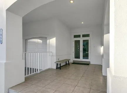 a bathroom with a granite countertop sink and white cabinets