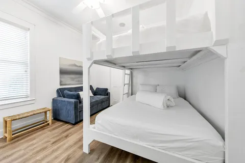 a kitchen with white cabinets sink and stove