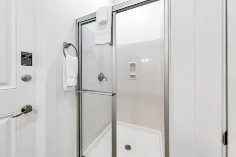 a bathroom with a sink and a mirror with bathtub