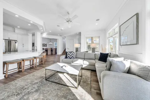 a living room with furniture and a dining table