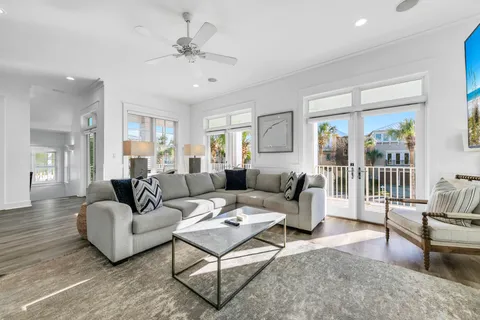a living room with furniture and a large window with balcony view