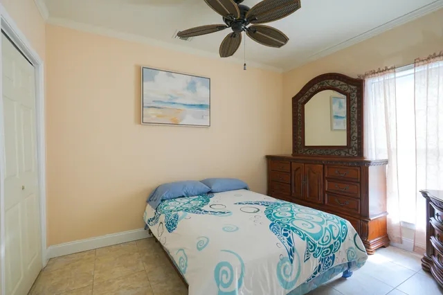 a bedroom with a bed and a mirror on dresser