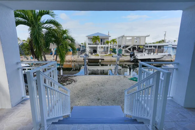 an aerial view of a house with garden space and street view
