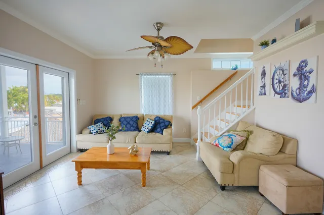 a living room with furniture and stairs