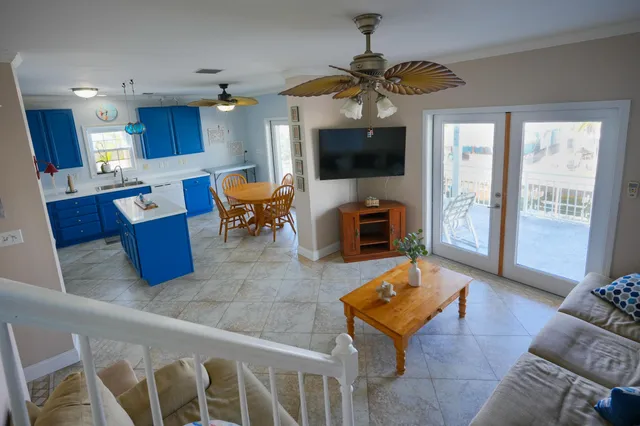 a kitchen with stainless steel appliances granite countertop a dining table chairs sink and cabinets