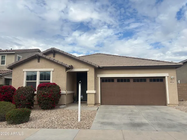a kitchen with kitchen island granite countertop a sink stove and refrigerator