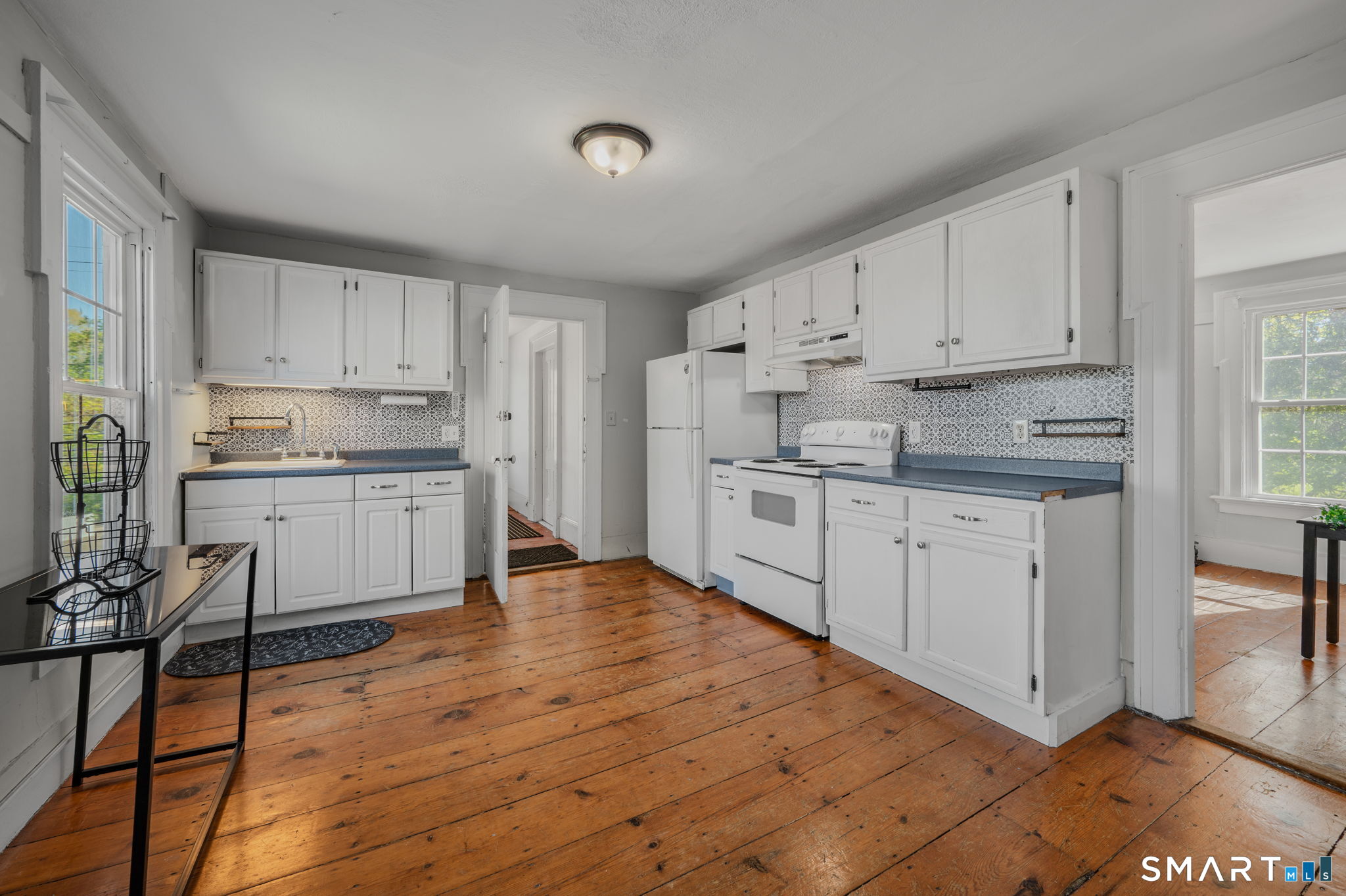 22 West High Street East Hampton, CT 06424 - Photo 20 of 40 a kitchen with white cabinets stainless steel appliances and a window