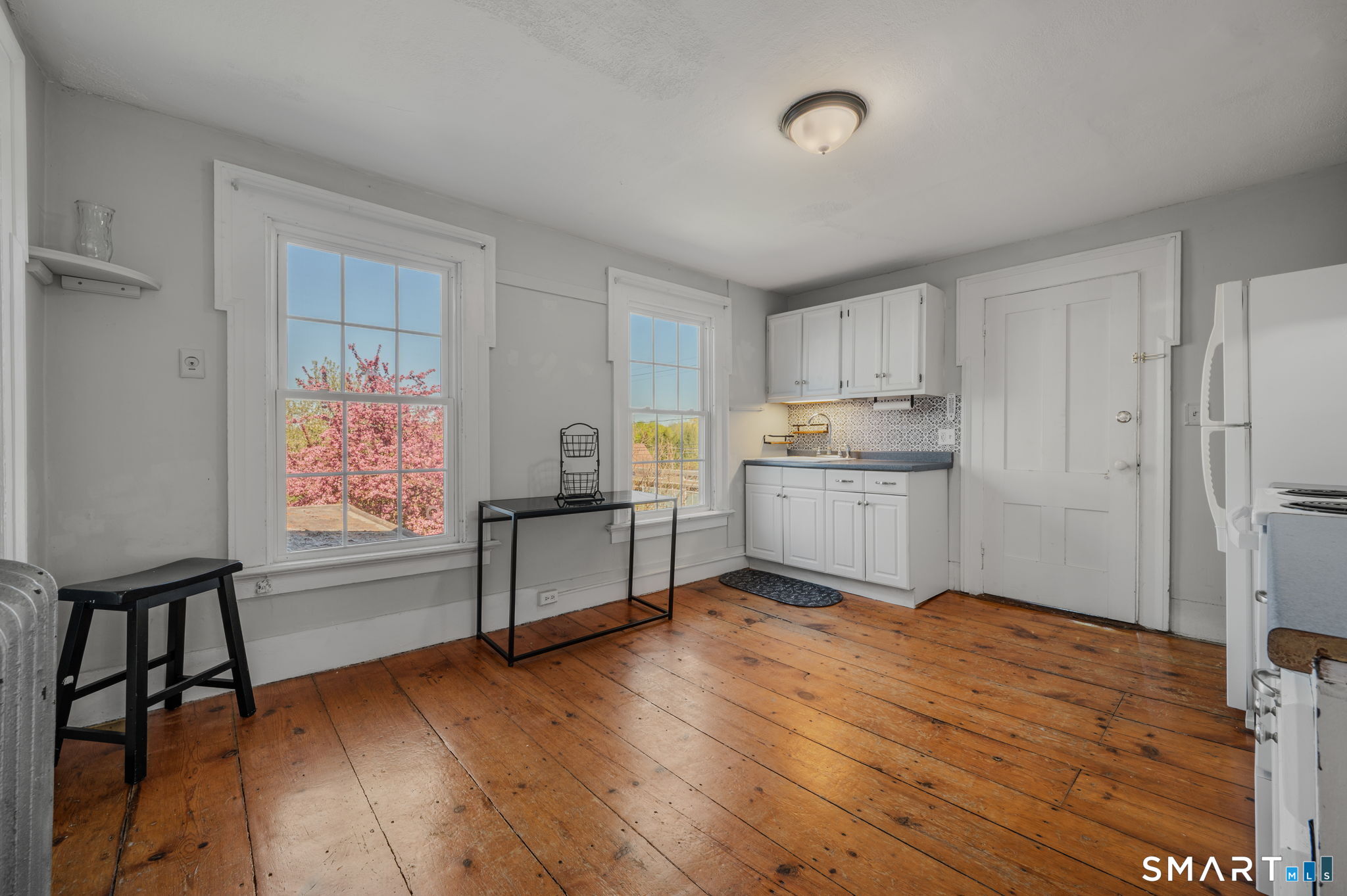 22 West High Street East Hampton, CT 06424 - Photo 22 of 40 a kitchen with granite countertop wooden floors and white stainless steel appliances