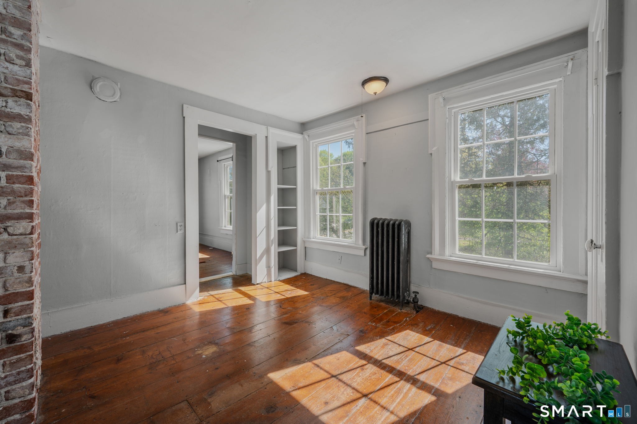 22 West High Street East Hampton, CT 06424 - Photo 23 of 40 an empty room with wooden floor and a window