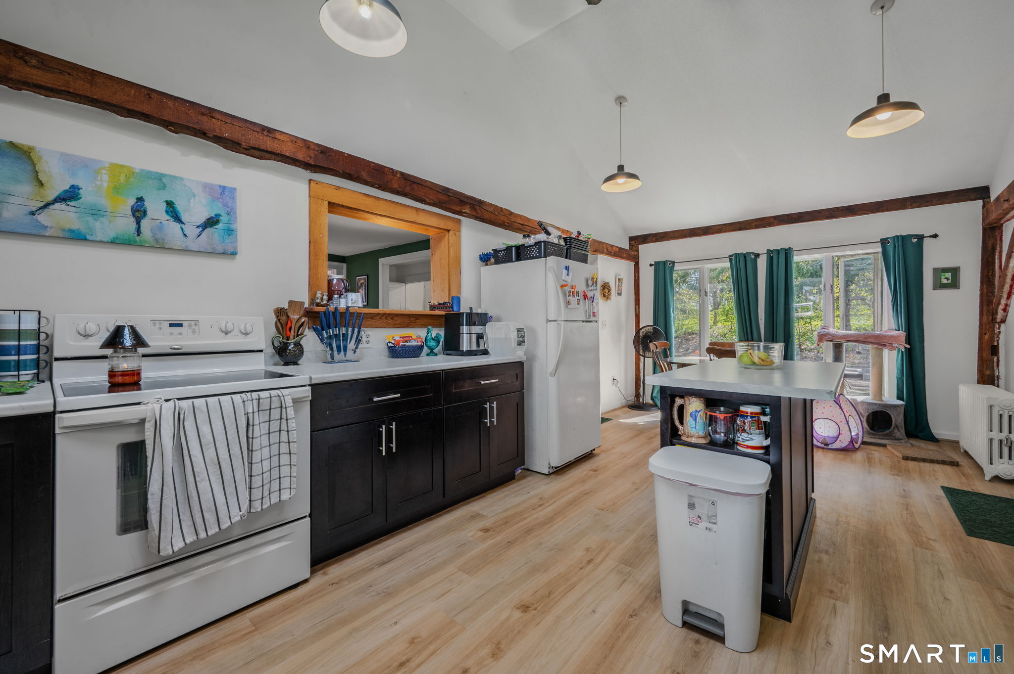 22 West High Street East Hampton, CT 06424 - Photo 7 of 40 a kitchen with stainless steel appliances granite countertop a stove top oven a sink a dining table and chairs with wooden floor