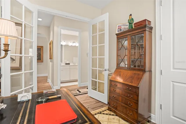 a view of a lake with a yard and large trees