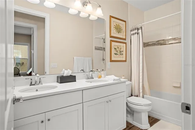 a front view of a house with a garden and trees