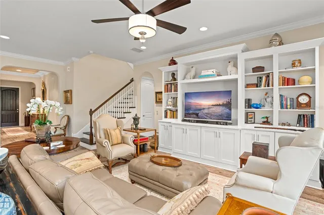 a kitchen with stainless steel appliances granite countertop a table chairs refrigerator and microwave