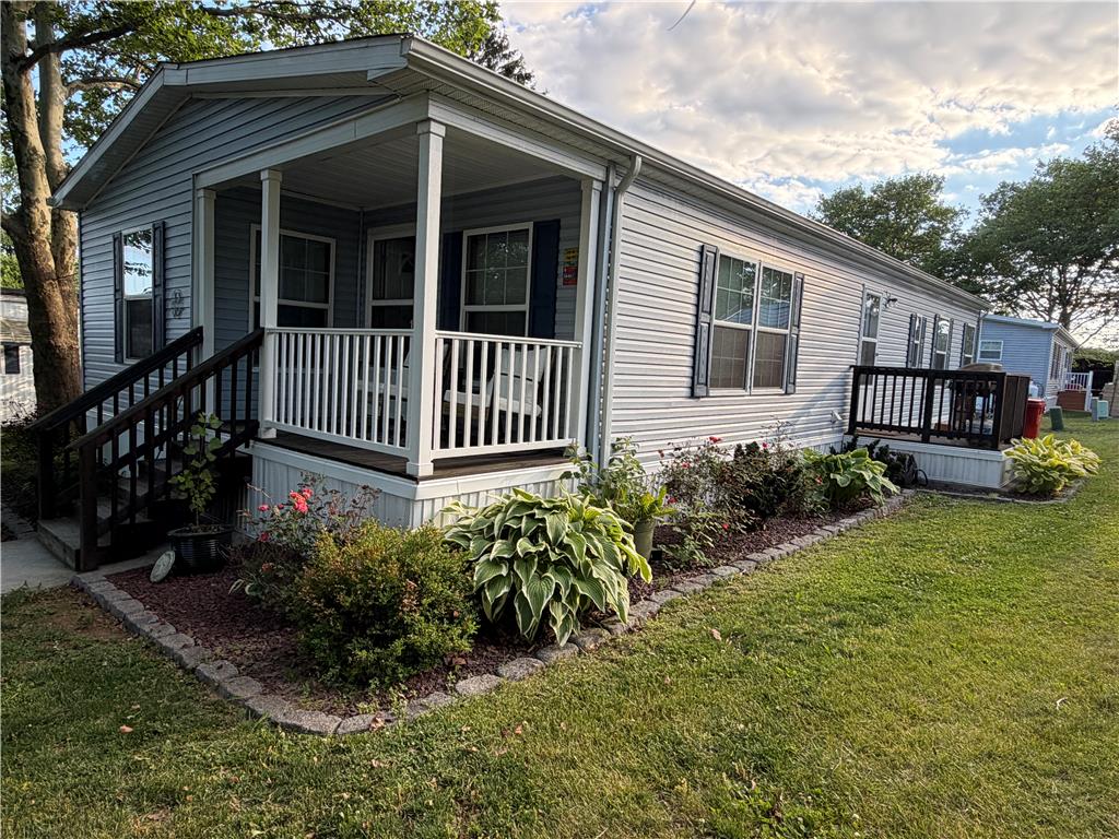 12 Springridge Road Bath, PA 18014 - Photo 40 of 61 Well-maintained manufactured home features a covered porch and tidy landscaping for welcoming curb appeal.