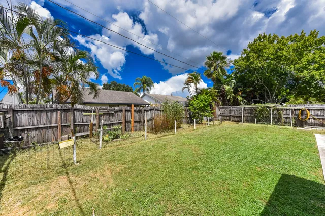a view of yard with swimming pool and green space