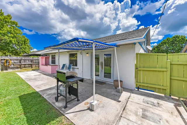 a view of a house with backyard porch and sitting area