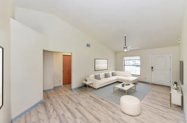 a living room with furniture and wooden floor