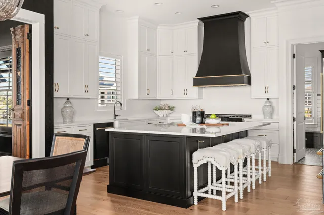 a kitchen with a sink and a stove top oven