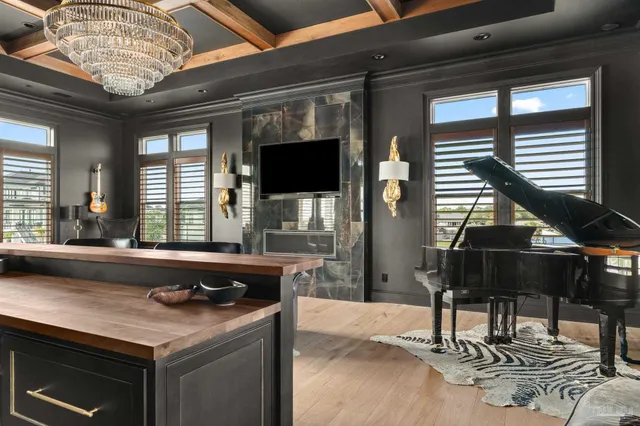 a view of a hallway with wooden floor and a potted plant
