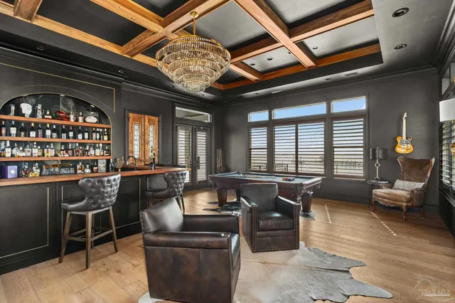 a bedroom with a bed a flat tv screen and a dresser