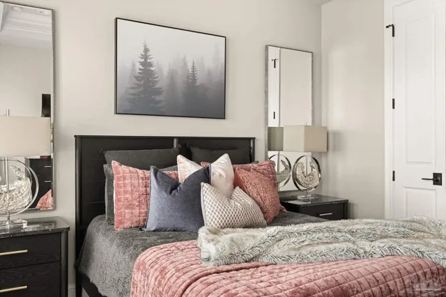 a living room with furniture and floor to ceiling windows