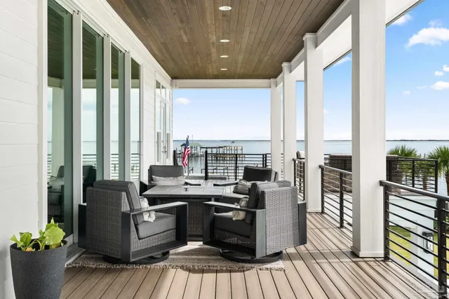 a view of a house with a wooden deck and a yard
