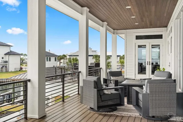 a balcony with table and chairs
