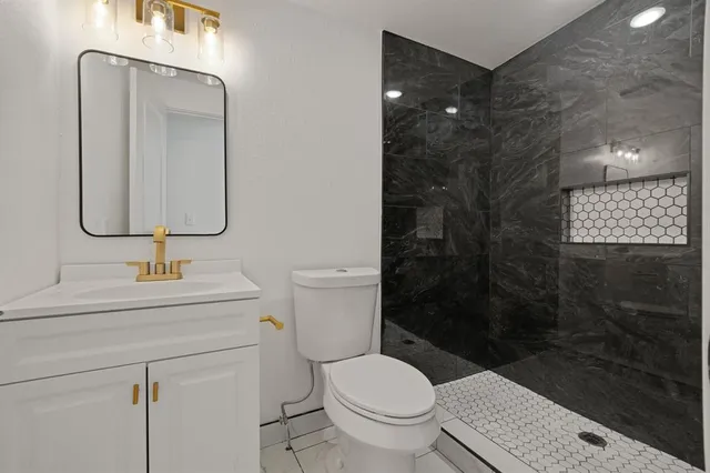 a bathroom with a toilet sink and shower