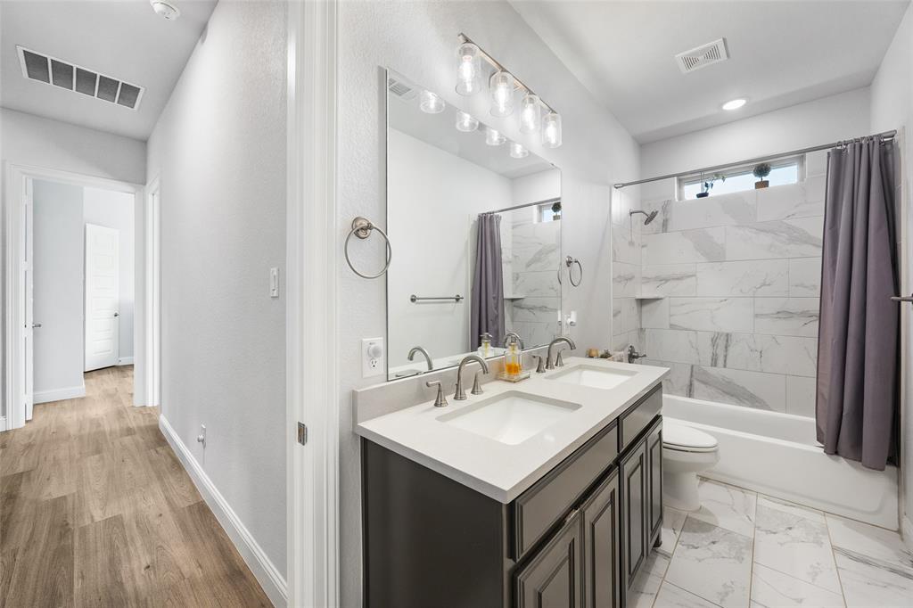 2628 Flycatcher Road Fort Worth, TX 76118 - Photo 29 of 38 Full bath with double vanity, shower / bath combination with curtain, and recessed lighting