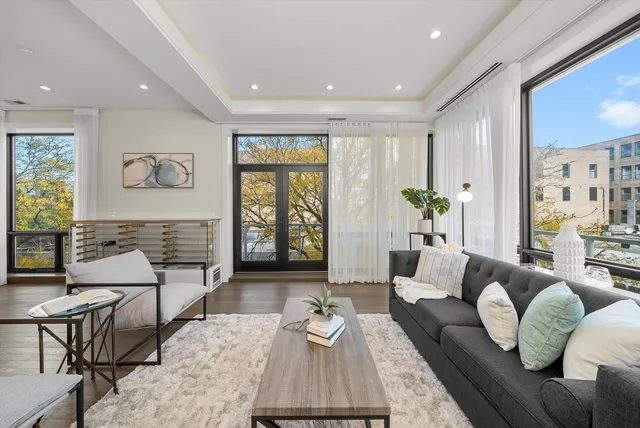 a large white kitchen with a large window