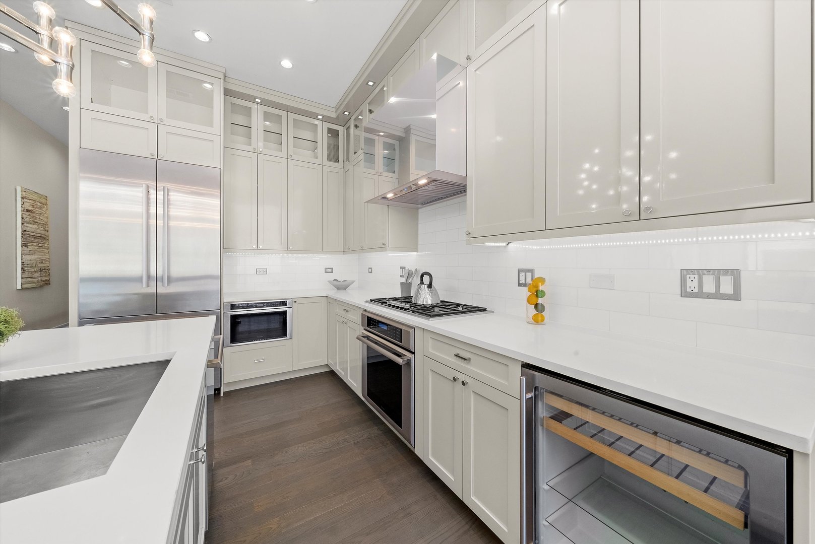1258 North Milwaukee Avenue, Unit 3N Chicago, IL 60622 - Photo 16 of 36 a kitchen with stainless steel appliances white cabinets and a stove top oven