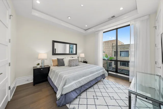 a bedroom with a bed and a lamp