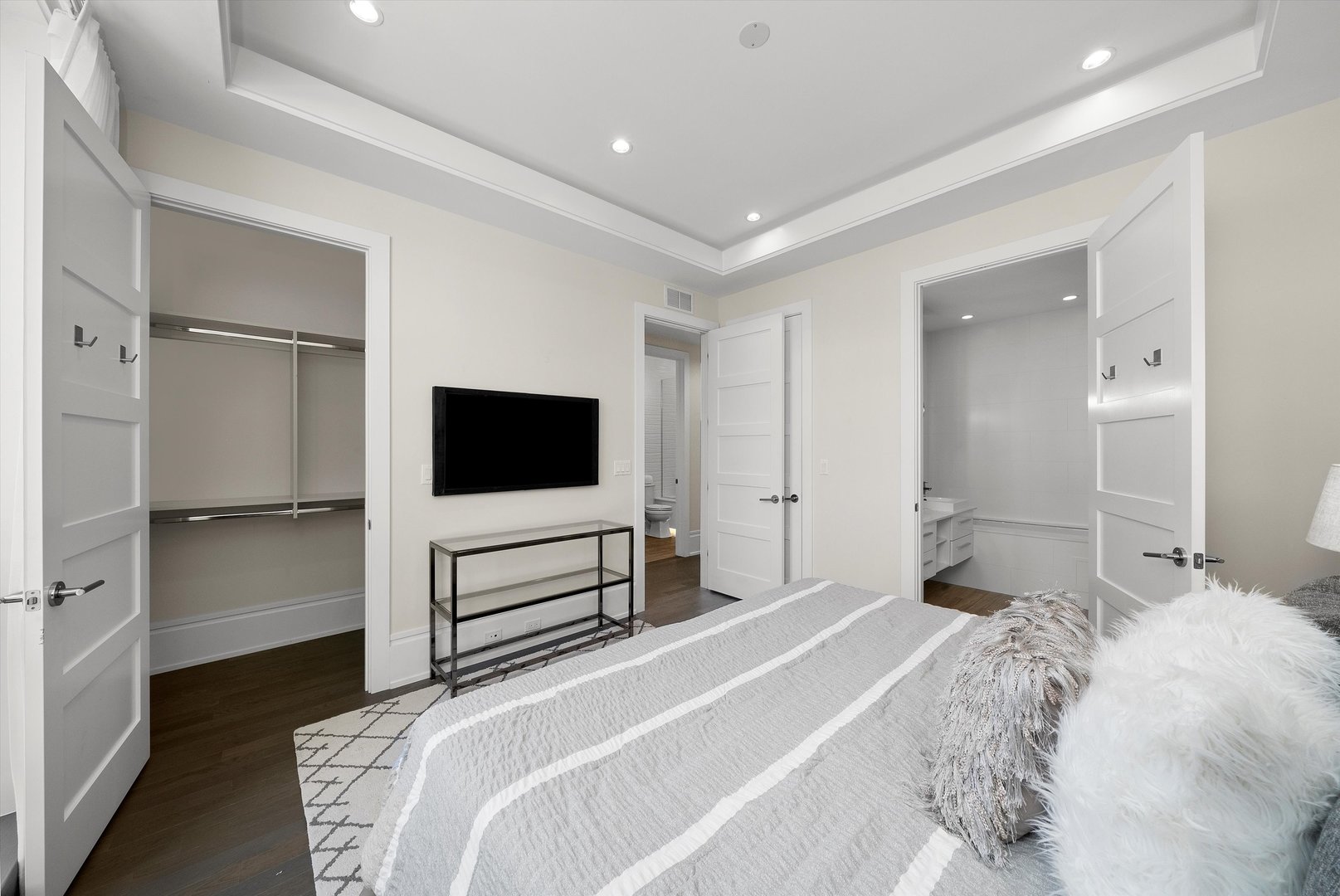 1258 North Milwaukee Avenue, Unit 3N Chicago, IL 60622 - Photo 19 of 36 a bedroom with a bed and a flat screen tv