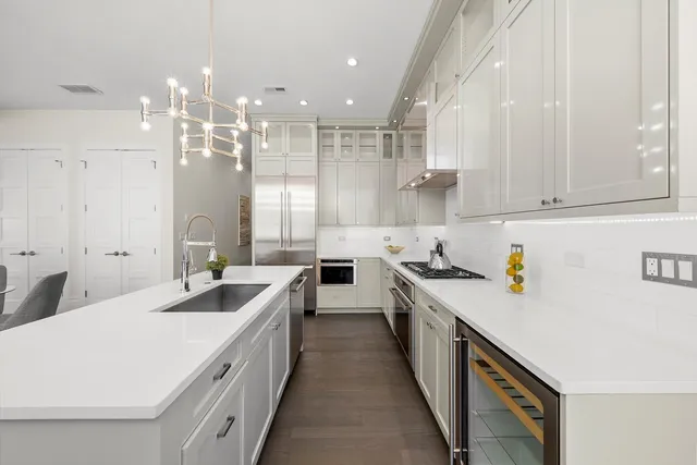 a living room with furniture a large window and wooden floor