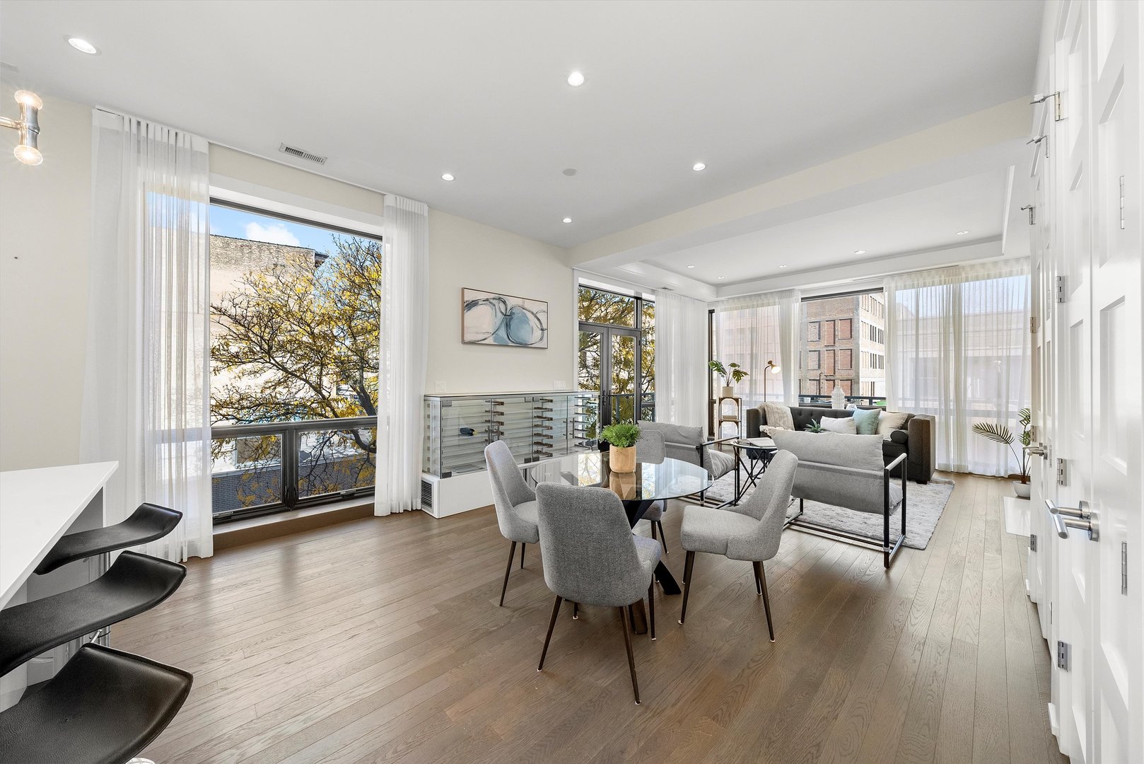 1258 North Milwaukee Avenue, Unit 3N Chicago, IL 60622 - Photo 5 of 36 a living room with furniture a large window and wooden floor