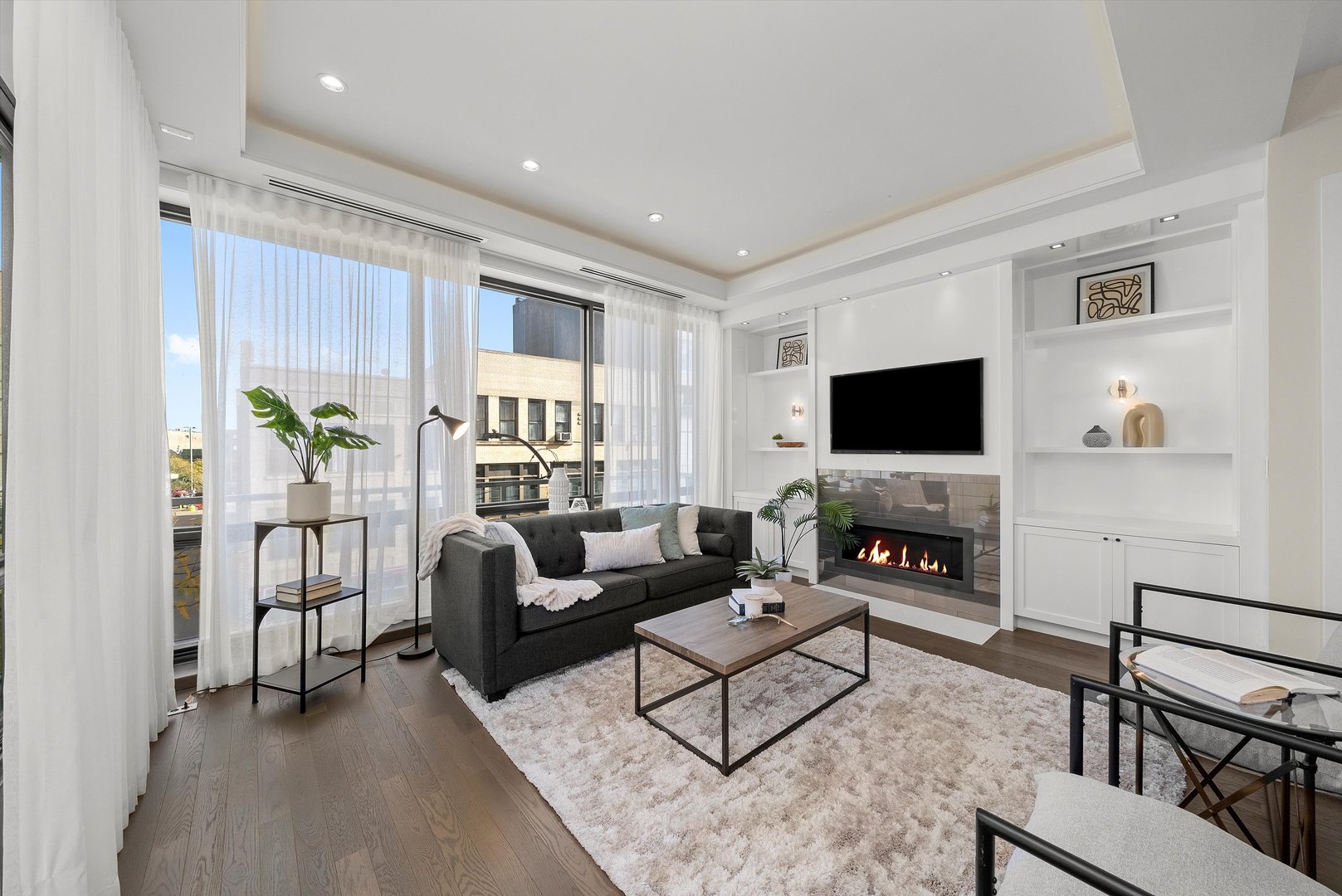 1258 North Milwaukee Avenue, Unit 3N Chicago, IL 60622 - Photo 8 of 36 a living room with furniture and a flat screen tv