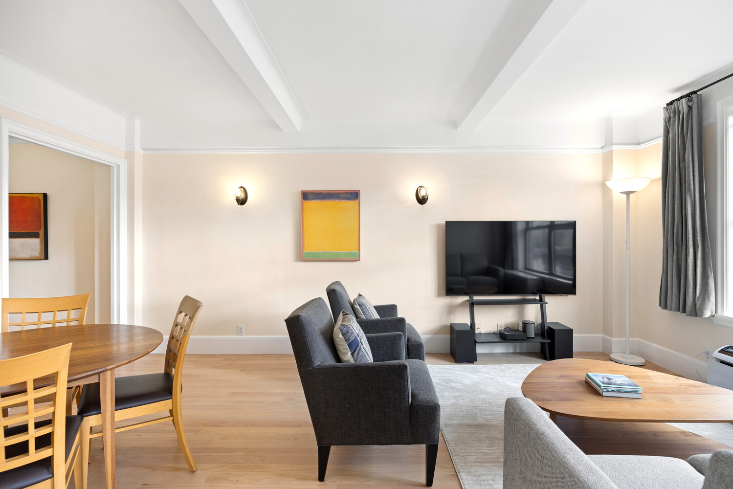 40 West 77th Street, Unit 10D Manhattan, NY 10024 - Photo 2 of 9 a living room with furniture and a flat screen tv