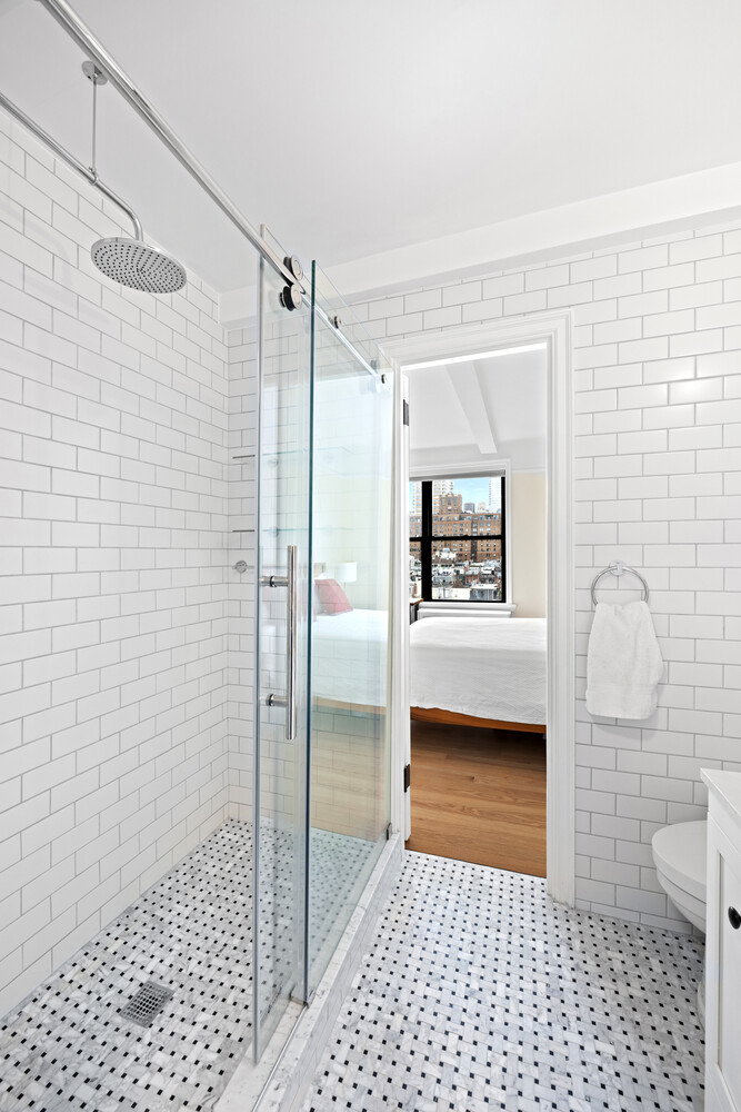 40 West 77th Street, Unit 10D Manhattan, NY 10024 - Photo 6 of 9 a bathroom with a sink a toilet and shower