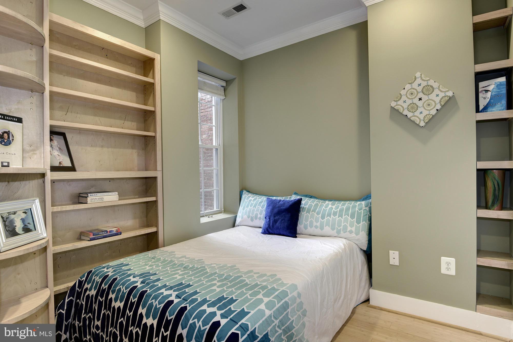 1126 Columbia Road Northwest, Unit 3 Washington, DC 20009 - Photo 12 of 23 a bedroom with a bed and cabinets