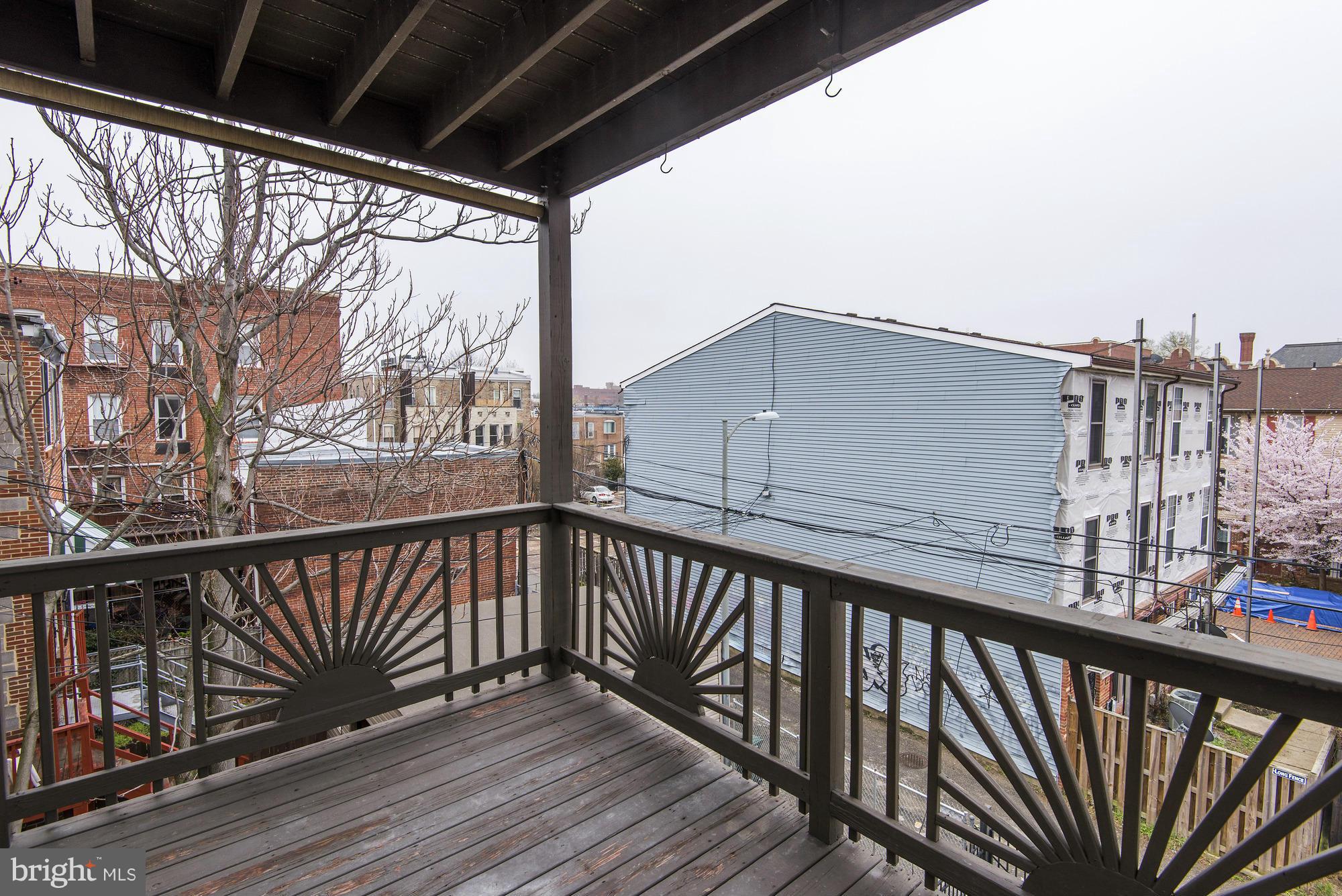 1126 Columbia Road Northwest, Unit 3 Washington, DC 20009 - Photo 19 of 23 a view of balcony with wooden floor and fence